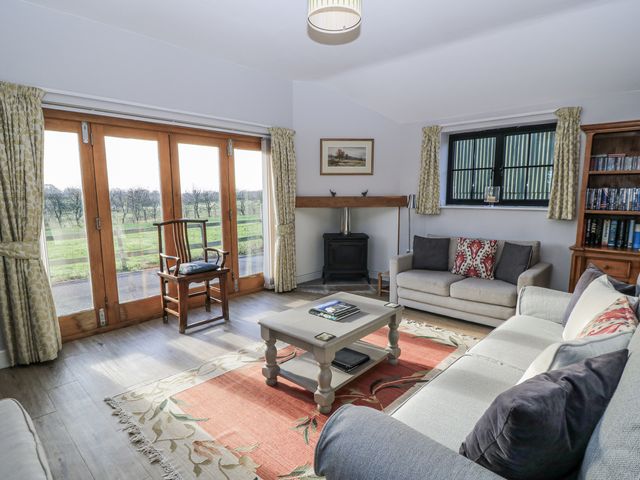 A living room with a sofa and coffee table at Keepers Cottage in West Knoyle