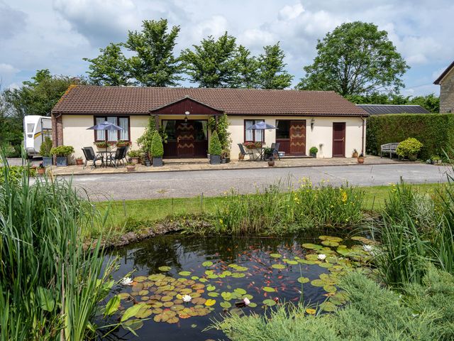 A building with a garden and pond at Little Barn in Cucklington near Wincanton