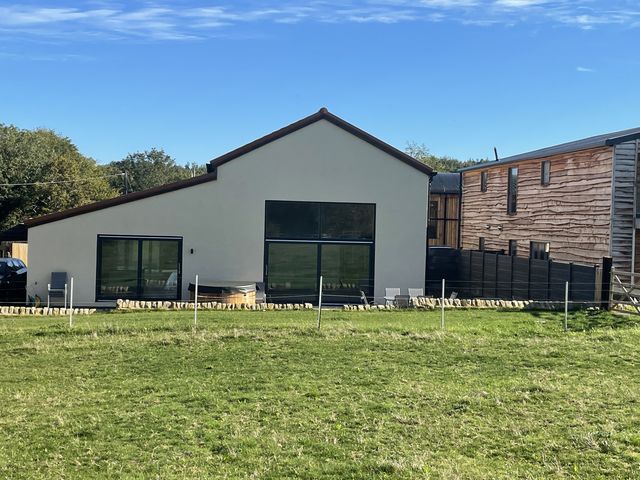 A modern house with large windows at 1 New Dairy Barn
