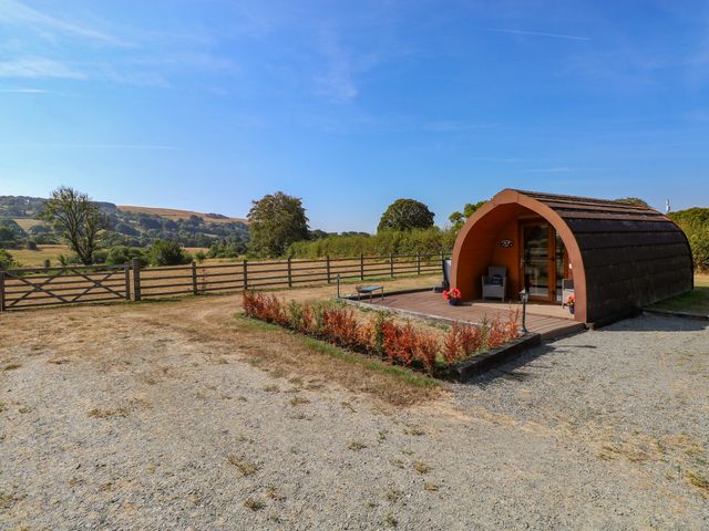 A pod with a wooden deck in a rural landscape at Bwthyn Bach Brefi Llanddewi-Brefi