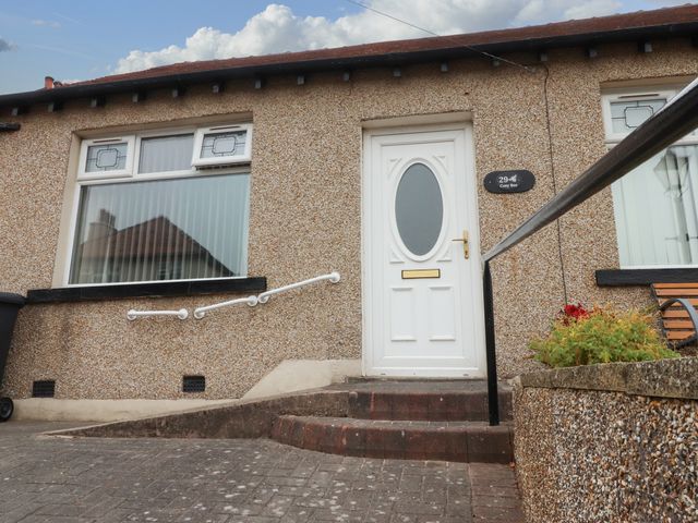 A front entrance with steps and a door at Cosy Bee in Heysham