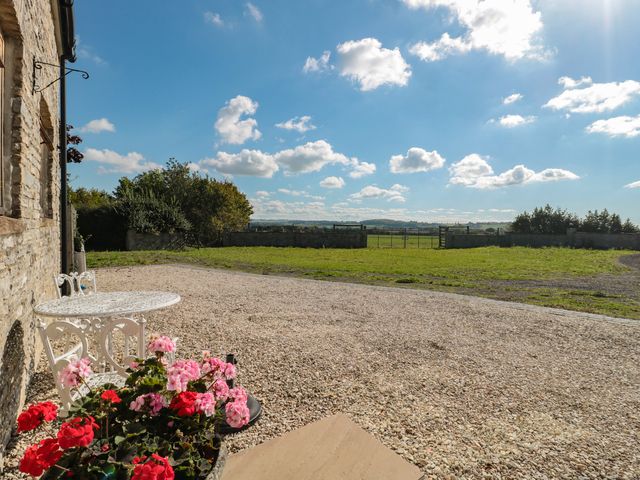 An outdoor area with flowers and a table at Bramble Cottage in Somerton