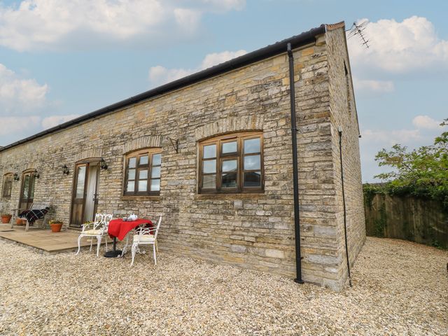 An outdoor seating area with a table and chairs at Bramble Cottage in Babcary near Lydford-On-Fosse
