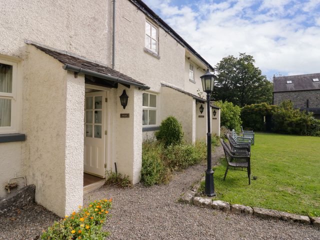 An exterior view of a house with a garden at Longlands Milkmaid's Parlour near Grange-over-Sands