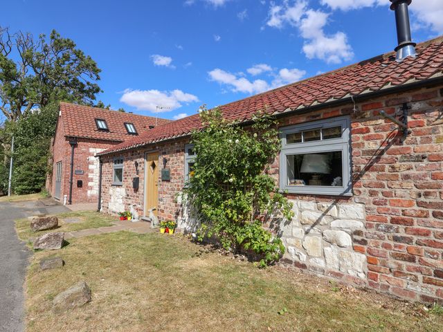 An exterior view of a barn with a pathway and garden at 1 Church Barns Pocklington