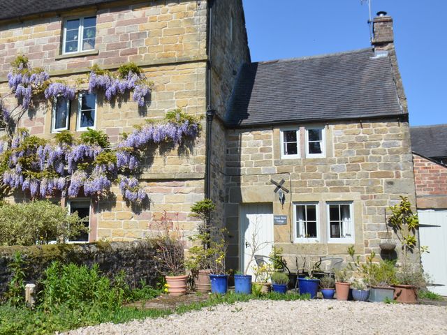 A house with wisteria flowers at Green Farm Cottage in Hognaston near Carsington Water