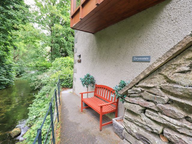 An outdoor area with a bench and pathway at Drystones in Grasmere