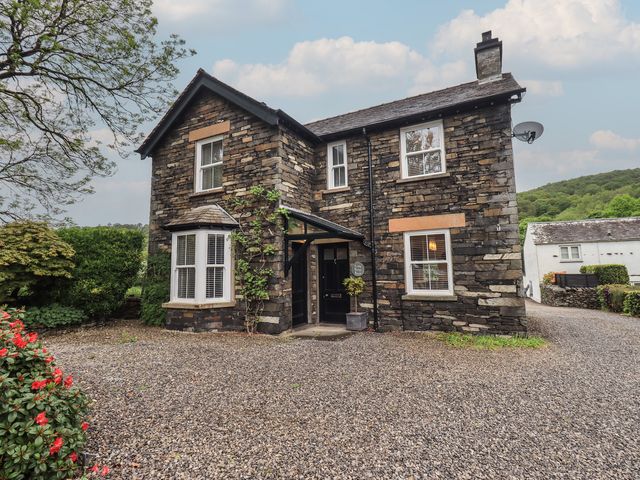 A house with stone walls and a gravel driveway at Newby Bridge House in Newby Bridge