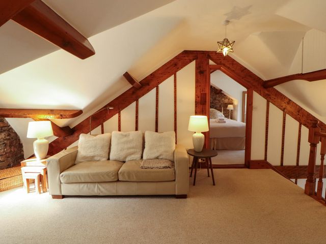 A living room with a sofa and lamps at High Raise in Grasmere