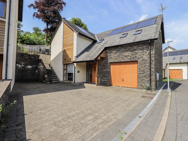 A house with a garage and driveway at No 7 Ambleside