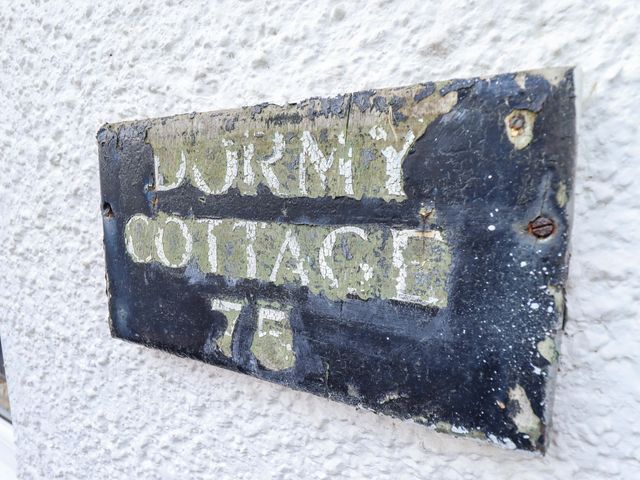 A sign displaying Dormy Cottage 76 located outdoors at Dormy Cottage Skegness