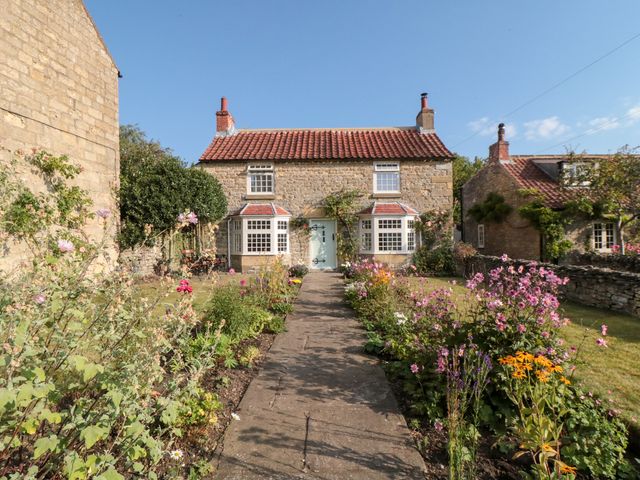 A house with a pathway and garden at Bute Cottage in Lockton near Pickering