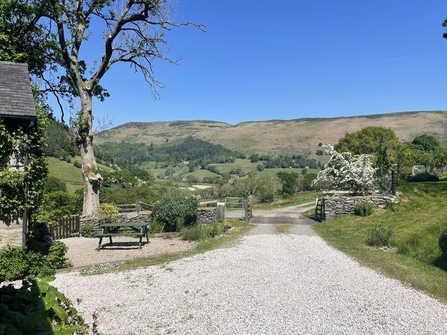 Outdoor view with a driveway and hills at Graig Las The Barn Llangynog near Llanrhaeadr-Ym-Mochnant