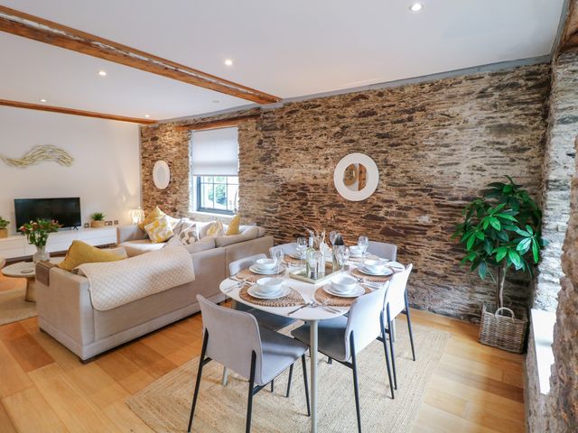 A dining area with a table set for meals at 9 The Pottery Dartmouth