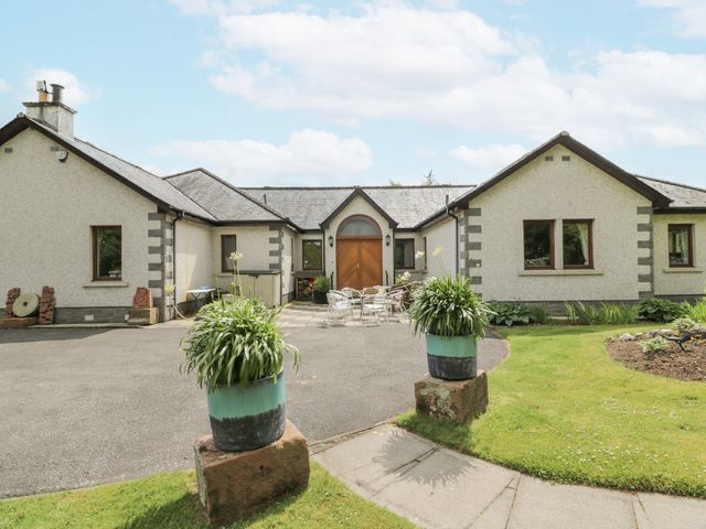 A house with a front door and seating area at Torview House Lyne Station near Peebles