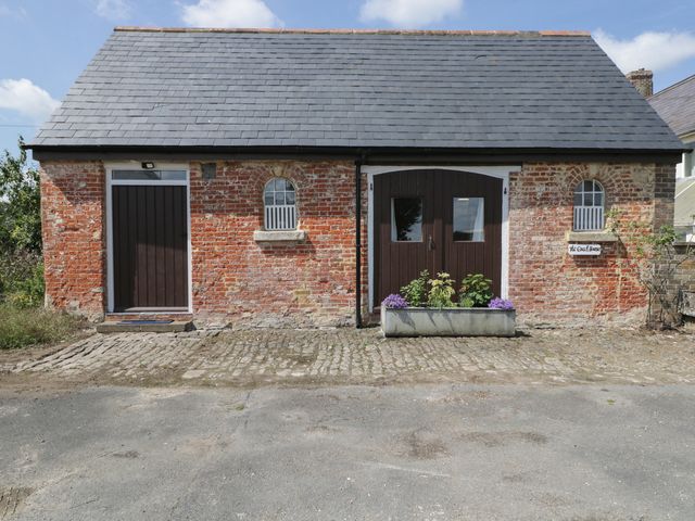 A building with two doors and a planter at Coach House in Swindon