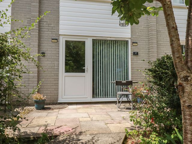 An outdoor entrance with a door and seating area at 49 Atlantic Reach Newquay
