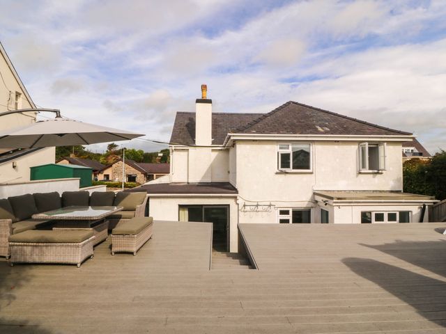 An outdoor seating area with a table and chairs at Afallon in Llanbedrog