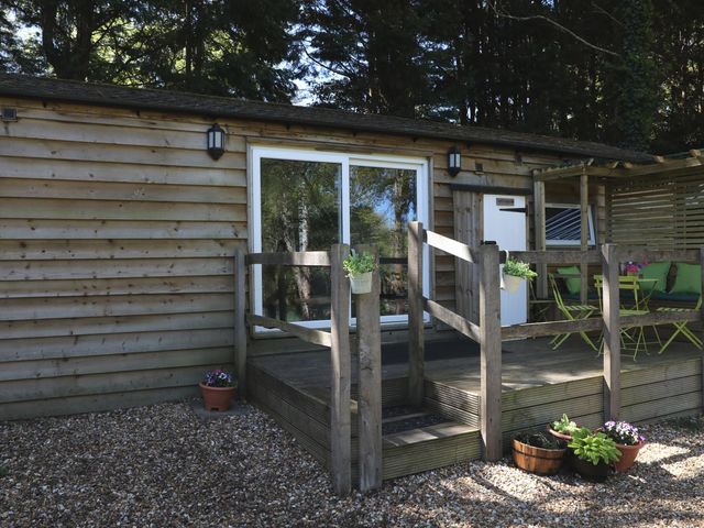 An outdoor seating area with plants at Harvest Lodge in Wineham near Bolney