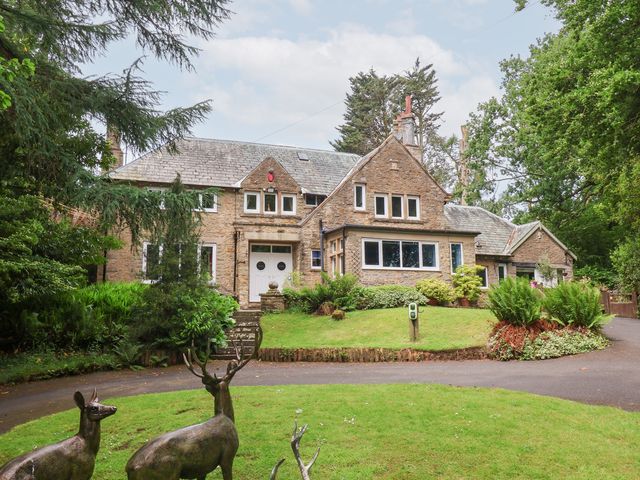 A building with a front yard and statues at Raincliffe Manor in Scarborough
