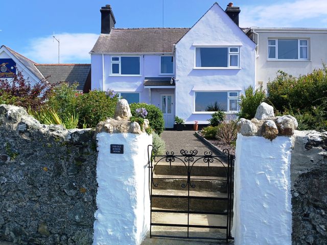 A house with a garden and gate at The Old School House in Cemaes Bay