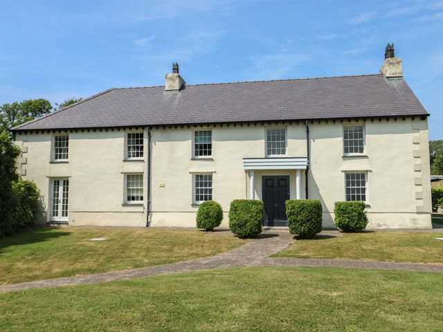 A house with greenery and a pathway at Clynnog House Dwyran near Newborough