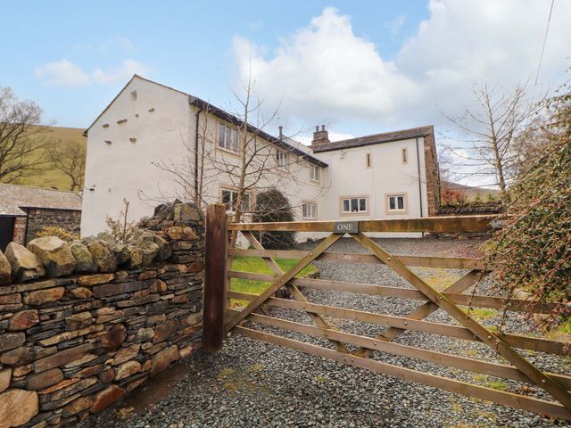 An outdoor view of a house with a gate at One Town End in Mungrisdale, Mosedale