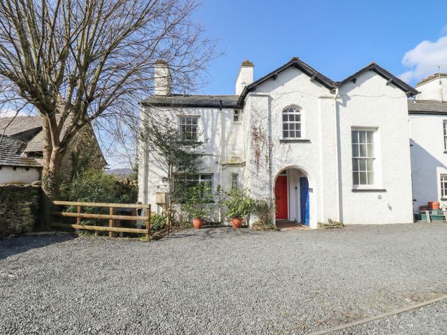 A house with a tree and gravel driveway at Red Screes in Ambleside