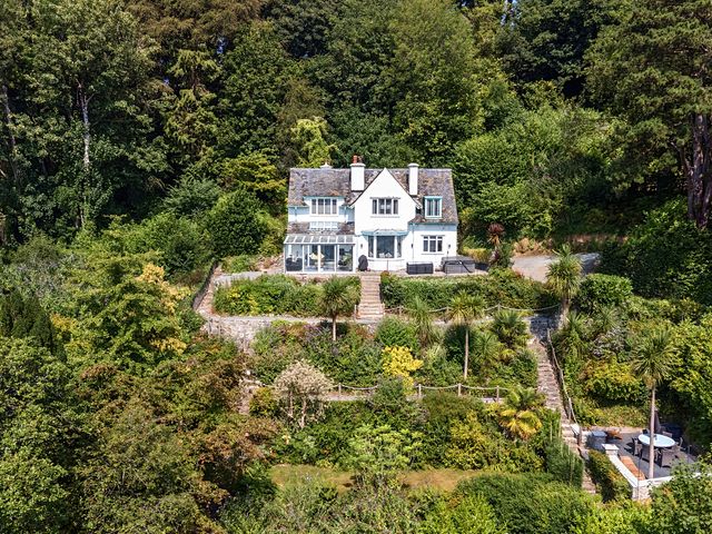 A house surrounded by greenery with a garden at Afallon in Menai Bridge