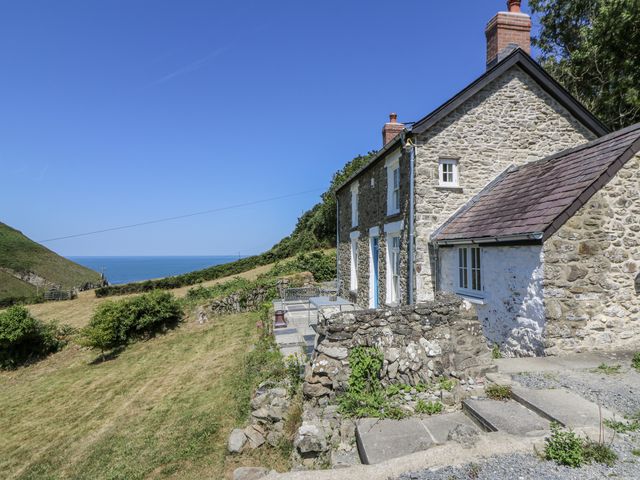 A house with a garden and patio overlooking the sea at Dolwylan Cottage Cwmtydu near New Quay