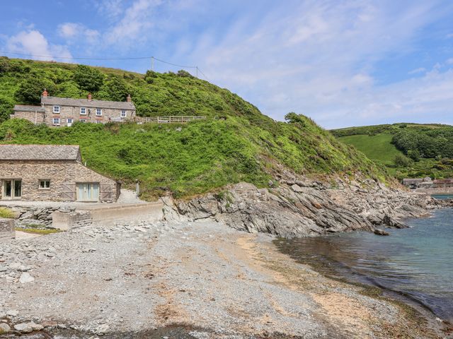 A view of houses and a rocky shore at 2 Cliff Cottages in West Portholland near Gorran Haven
