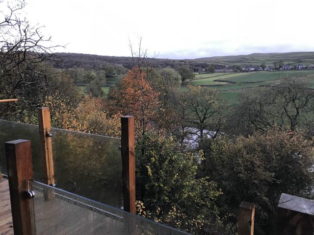 A view of a landscape with trees and a stream at The Sett on the Wharfe, Skipton