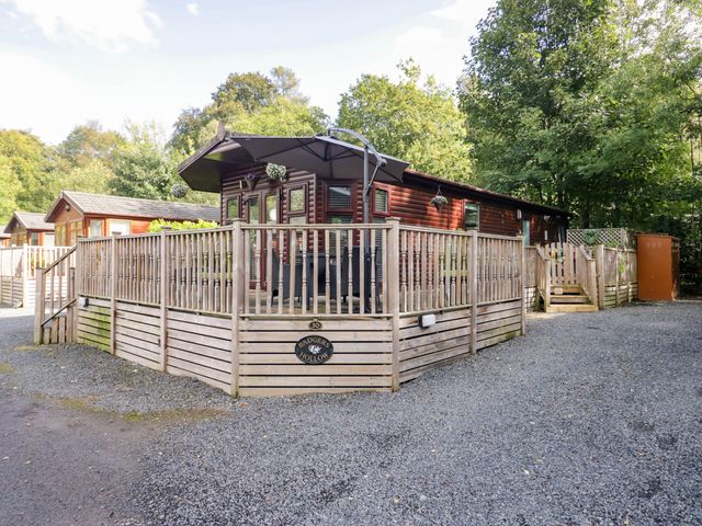 An outdoor space with a wooden lodge and decking at Badgers Hollow Lodge, Grasmere 30, White Cross Bay near Windermere