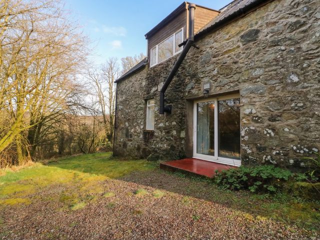 A stone wall with a door and window at Willow near Killean Farmhouse Cottages near Inveraray