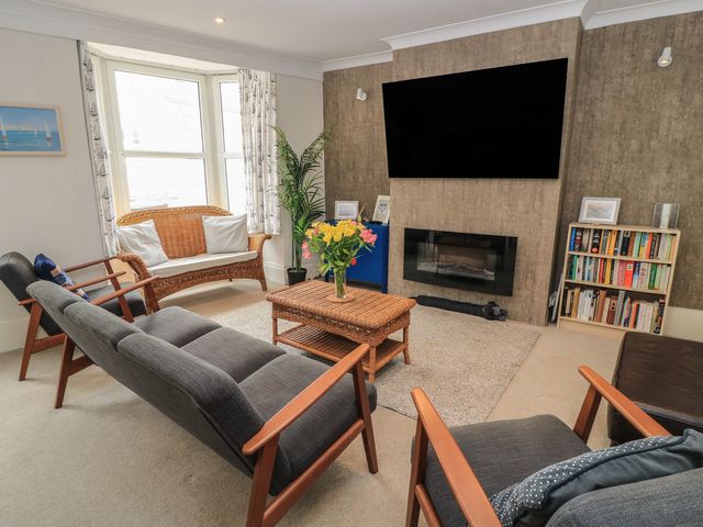 A living room with sofas and a coffee table at Still Waters in Swanage