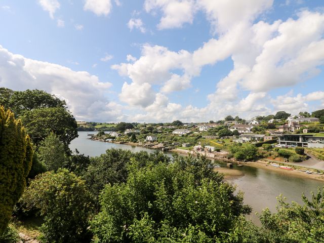 A river with houses and greenery on both sides at Rathillet in Feock near Truro