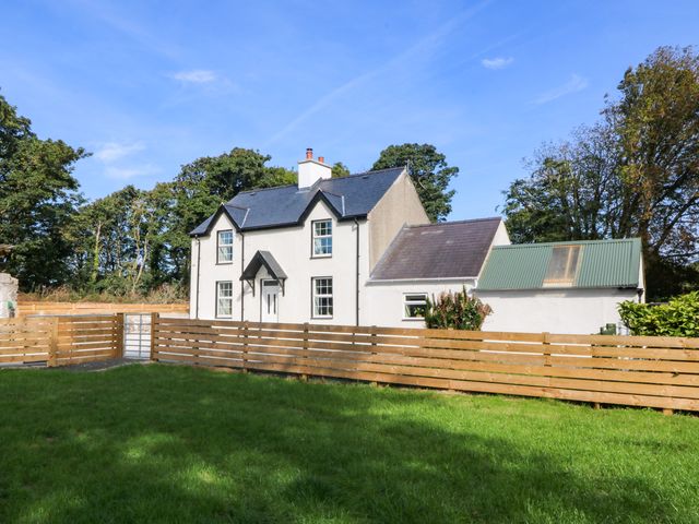 A house with a fenced yard at Gate House near Capel Coch in Llanerchymedd