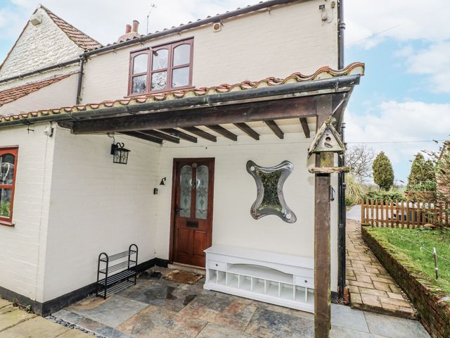 An entrance with a front door and a mirror at Woodpit Cottage Watnall