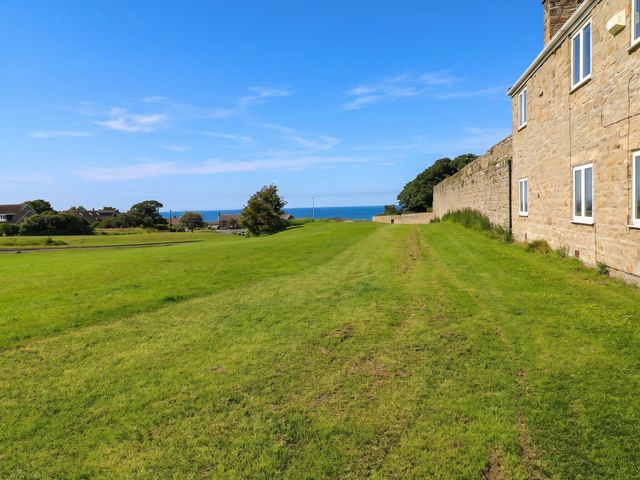 An outdoor view of grass and ocean at ASTA COTTAGE Cresswell