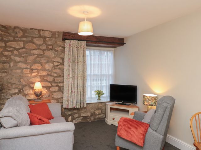 A living room with a sofa and television at Beck View