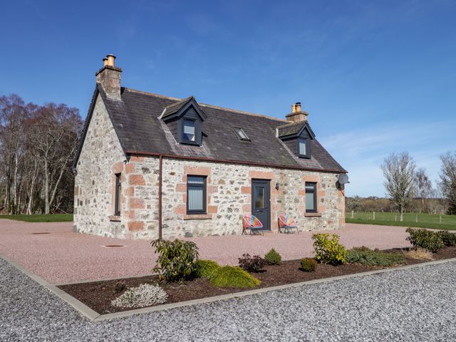 A house with chairs and garden at Nanville in Muir of Ord and Beauly