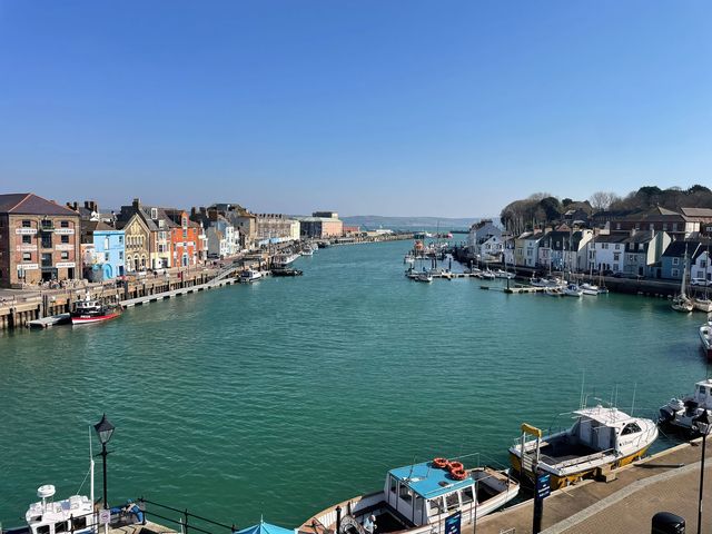 A view of the harbor with boats and buildings at Monarch in Brewers Quay Harbour