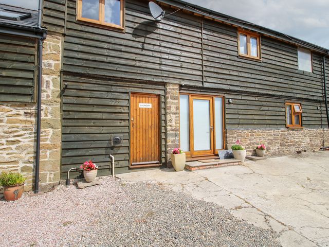 An exterior view showing a wooden door labeled laundry at Meadow Barn Aston On Clun