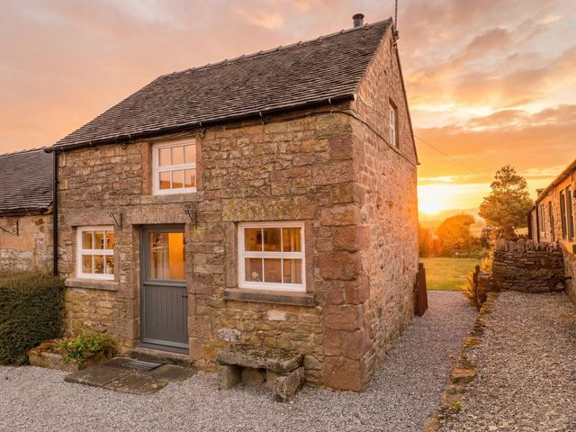 A stone house with front door and windows at The Dairy Middleton near Youlgreave
