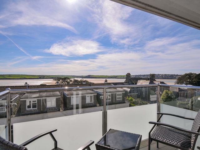 A balcony with chairs and a table overlooking a river at Slipway 15 in Rock