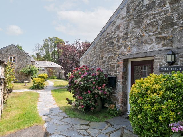 An outdoor area with stone buildings and a pathway at Mill Pond in Rock