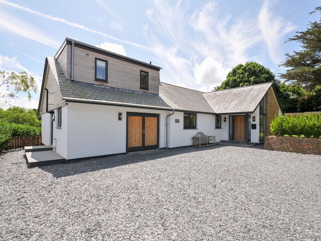 A house with a gravel driveway and outdoor seating at Porthilly Brook in Rock