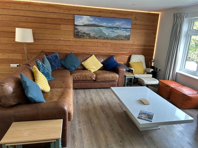 A living room with a sofa and coffee table at Beaches Polzeath
