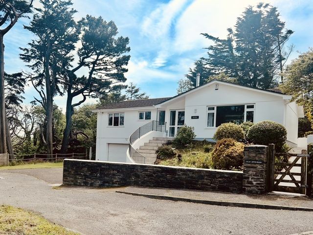 A house with a garage and steps at Beaches in Polzeath