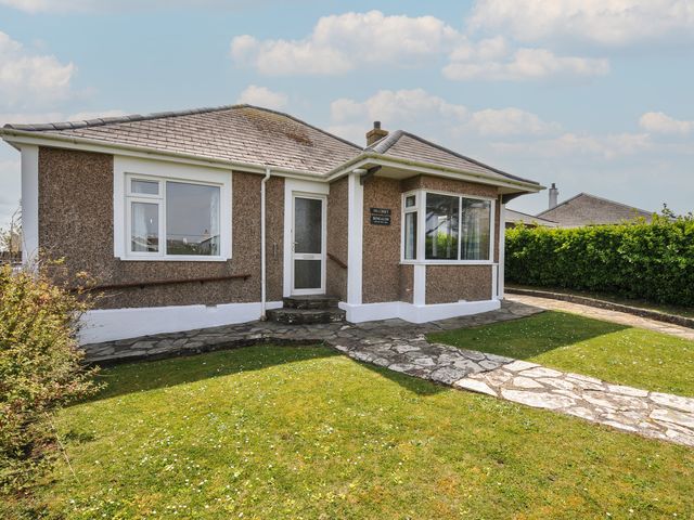 A bungalow with a pathway and garden at Hillcroft Bungalow Daymer Bay